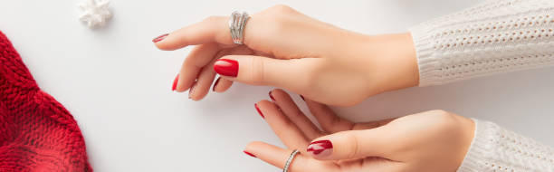Female hand with manicure on white background. Christmas Valentines day trendy shiny nail design. Social media template